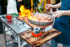 Chef cooking over a fire. A good chef knows how to use each ingredient for the best dish. team success.