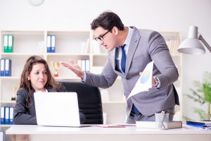 Unhappy worker being yelled at by the boss